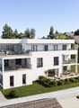 Modern white house, 3 stories, multiple balconies, car parking
