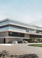 Modern office building, multiple stories, extensive use of glass facade, large driveway, multiple cars parked