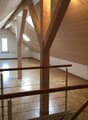 empty attic room, wooden beams, wooden floor, white walls, window, radiator