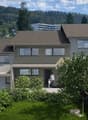 A contemporary two-story house with a brown roof, large windows, a small balcony, a spacious garden with a grassy lawn, surrounded by green foliage and a mountain range in the background.