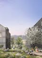 The image shows a residential complex with several multi-story wooden buildings surrounded by a lush, landscaped outdoor area. The buildings have balconies and large windows, and the outdoor space features trees, flowers, and a play area with logs for chi