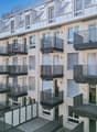 modern multi-story building, balconies, white and grey exterior