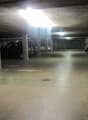 empty multistory underground parking lot with multiple pillars, no visible signs of damage