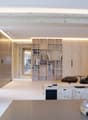 living room with wooden features, modern design, open shelves, armchairs, coffee table, books