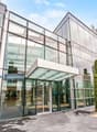 modern office building, glass facade, large entrance, glass doors, glass walls, modern design