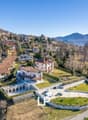 Large villa with multiple buildings, large garden, swimming pool, mountain view