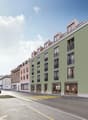 multi-story building, large windows, balconies, street shops, urban setting