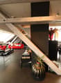 open space, modern furniture, red sofa, black dining table, plants, large windows