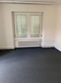 empty room, white walls, white radiator, double windows, gray carpet