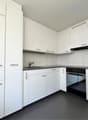 modern kitchen, fully equipped, modern appliances, white cabinets, gray countertops, open shelves