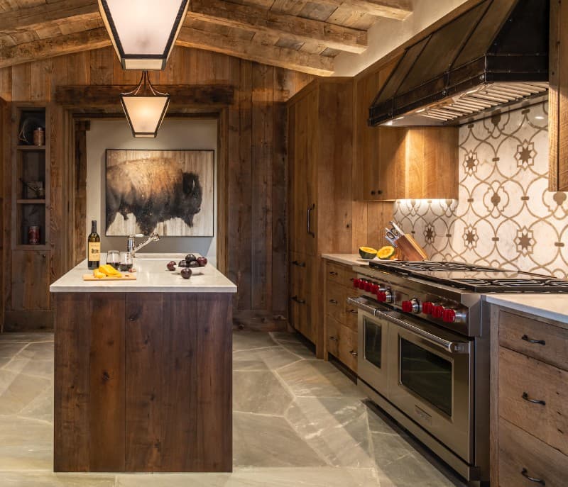wooden walls, wooden floor, central island, gas stove, wooden cabinets, hanging light