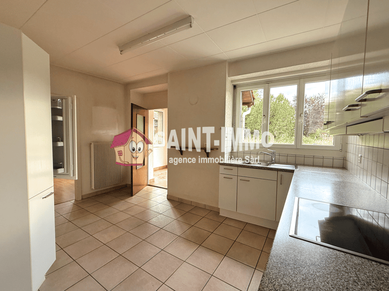 modern kitchen, white cabinets, grey tiled floor, stainless steel sink, window