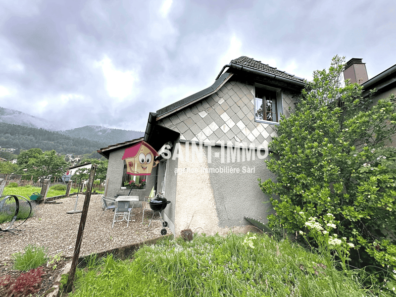 Stone exterior, gabled roof, gravel driveway, outdoor dining area, patio, greenery, outdoor plants, mountain view, chimney