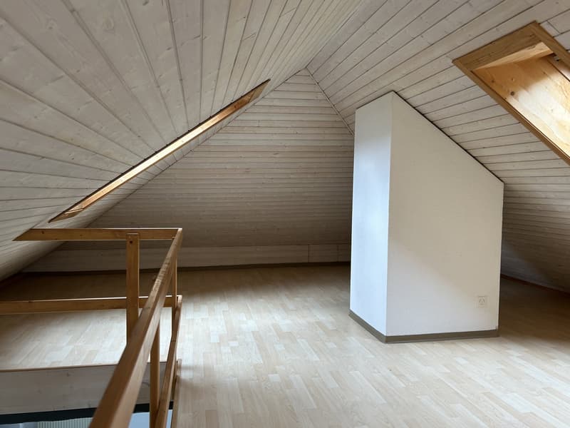 empty attic room, wooden ceiling, wooden floor, white wall, wooden railing