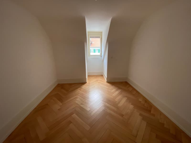 empty room, wooden parquet floor, small attic window