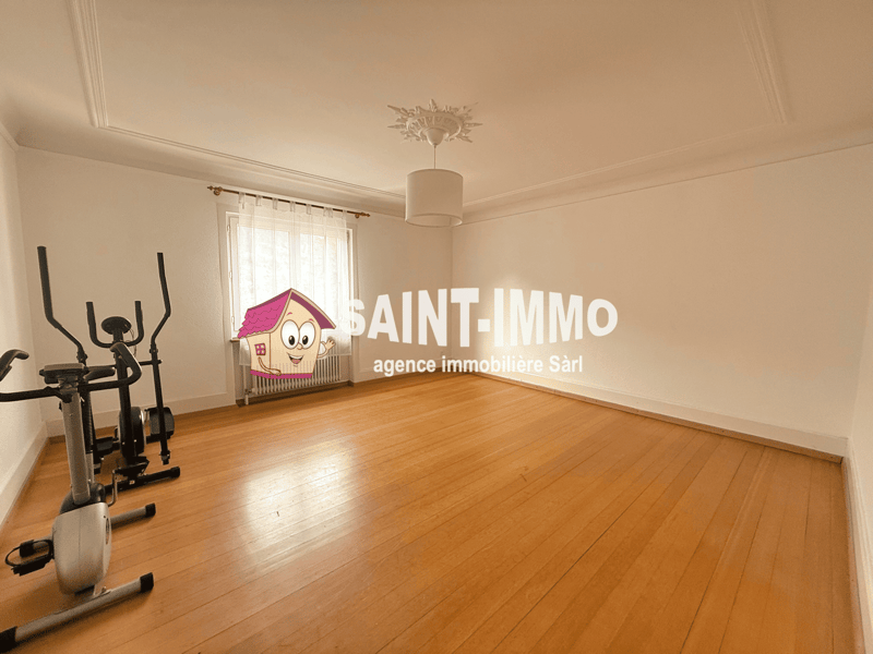 empty room, wooden floor, white walls, exercise equipment, window with curtains, radiator