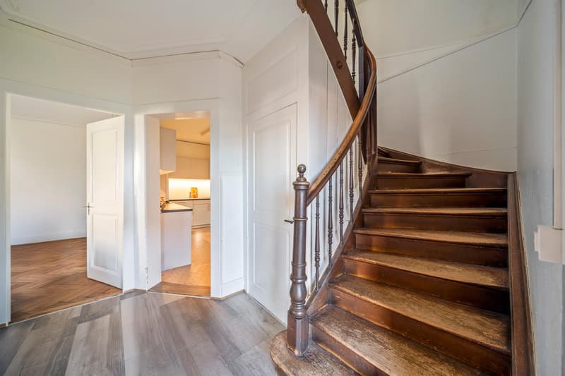 Wooden spiral staircase in a raised ground floor of a house