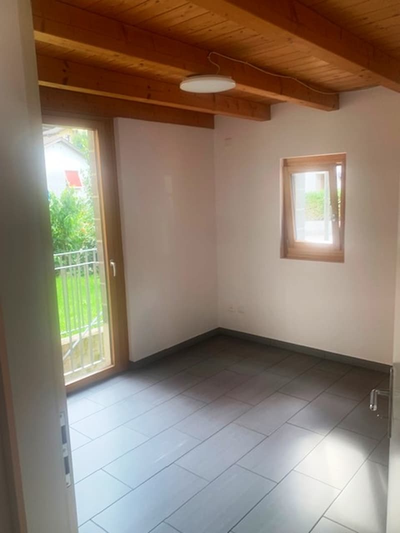 Tiled flooring, sliding glass door, small window, wooden ceiling beams, small balcony