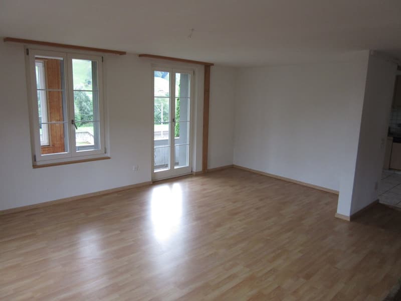 empty room, wooden floor, white walls, two windows, sliding door to balcony