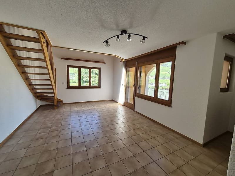 wide room with wooden floor, stairs, balcony, big windows