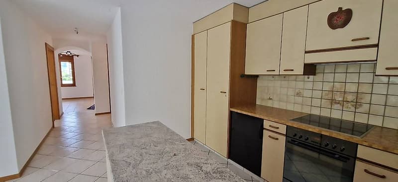 kitchen, tiled floor, white cabinets, countertop, stove, oven, tiled wall, open door