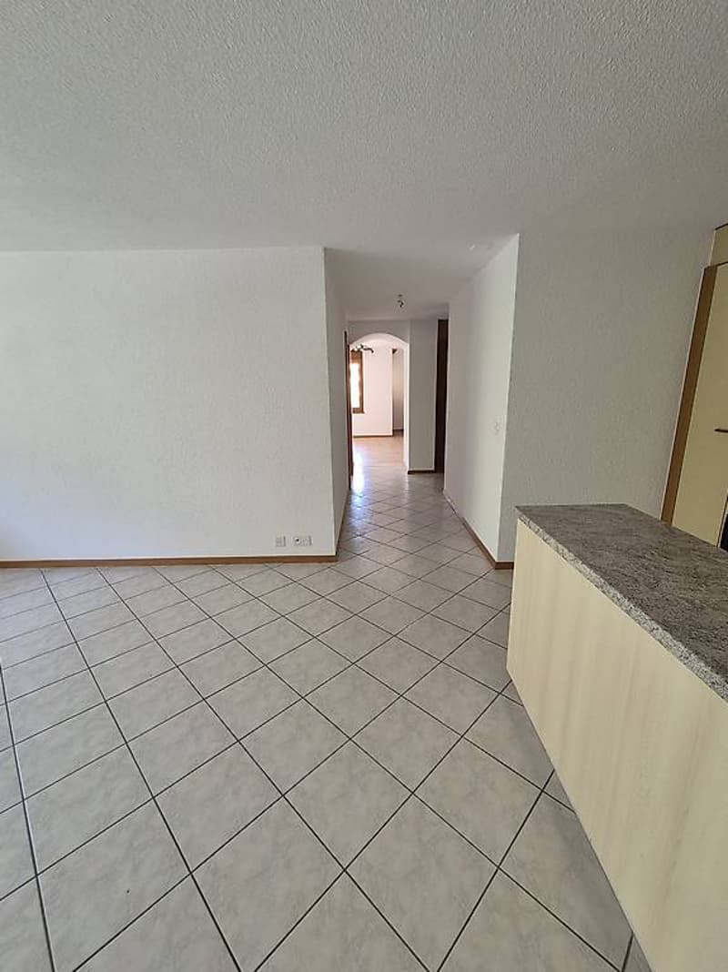 empty room with tiled floor and white walls