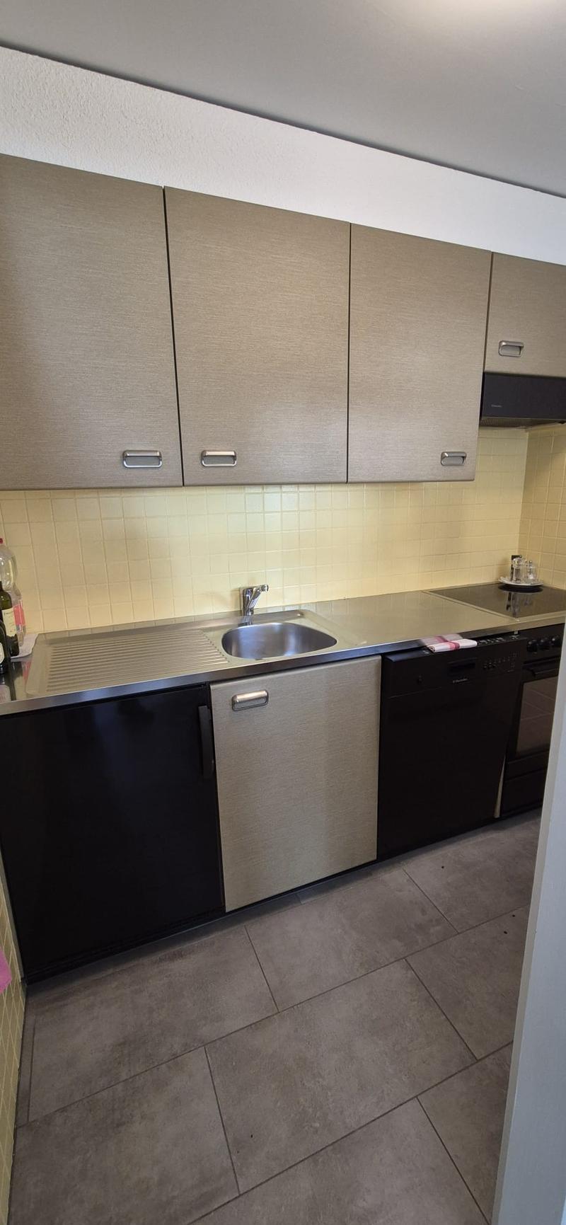 Kitchen: stainless steel countertops, stainless steel sink, faucet, dishwasher, cabinets, tiles, gas stove, oven