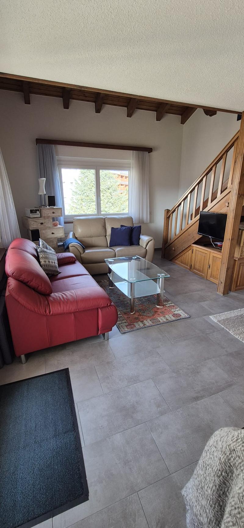 2 couches, tv, stairs, wooden floor, carpet, window