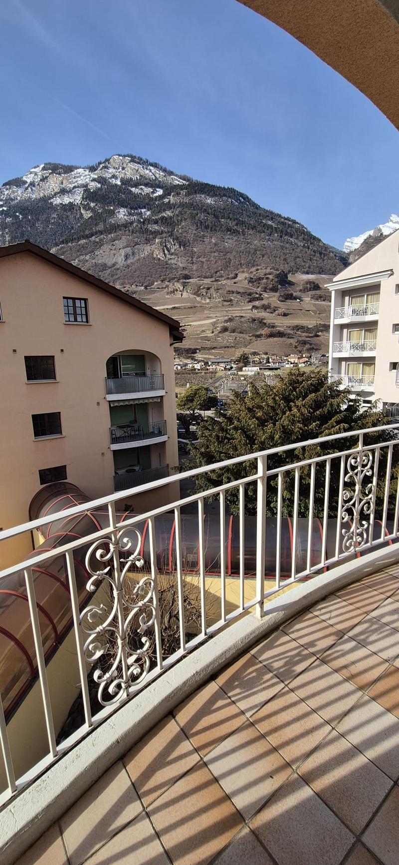 terraced balcony, tiled flooring, metal railings, views of the village and mountains