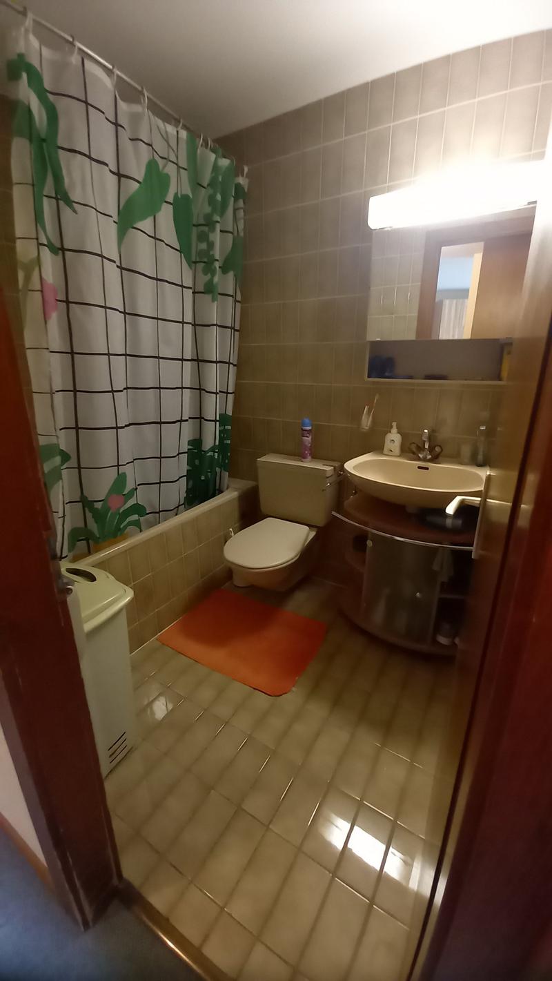 Bathroom with bathtub, toilet, sink, mirror, and shower curtain