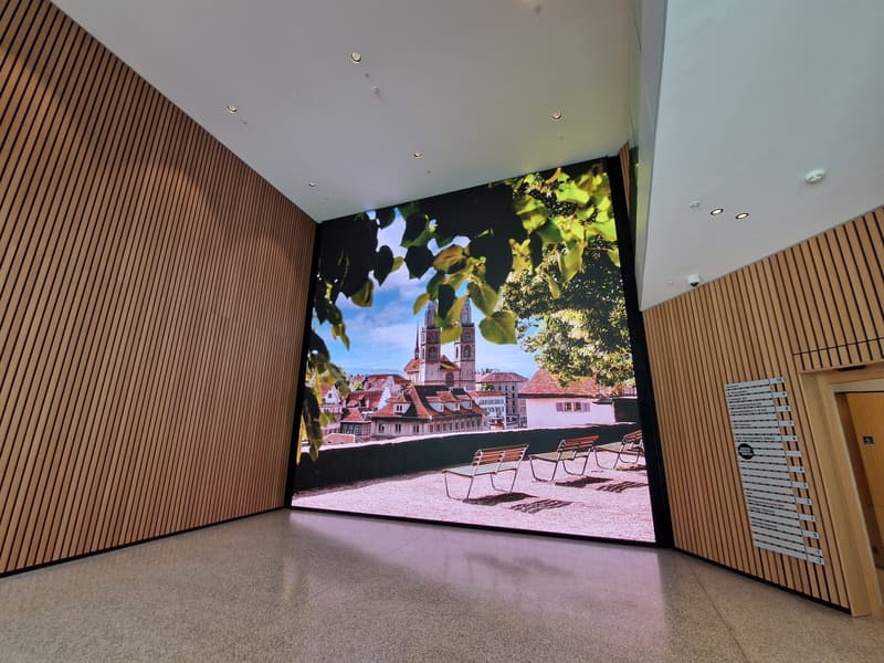 large display showing balcony with chairs, wooden walls, tiled floor, modern lighting