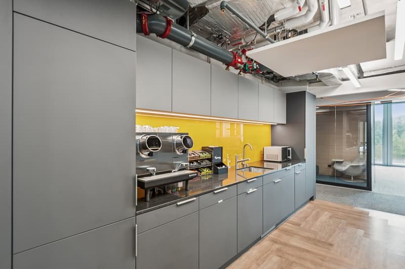 modern industrial kitchen, grey cabinetry, yellow accent wall, under-mount sink, stainless steel appliances