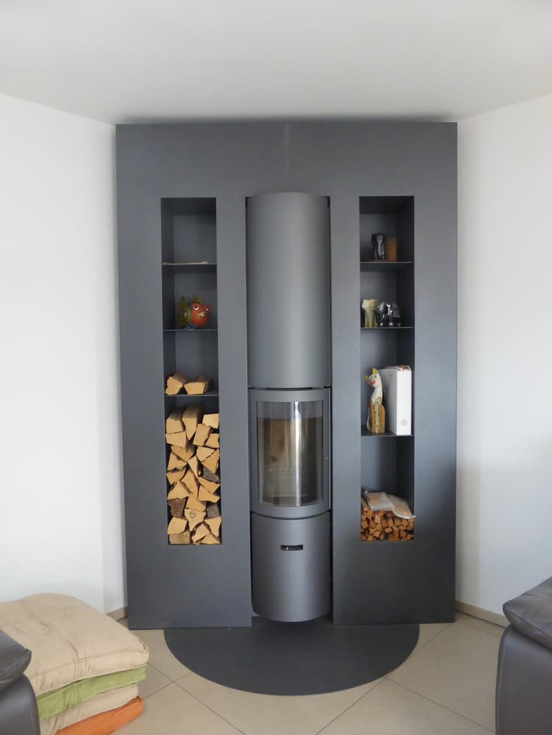 grey built-in fireplace with shelves and logs storage on both sides