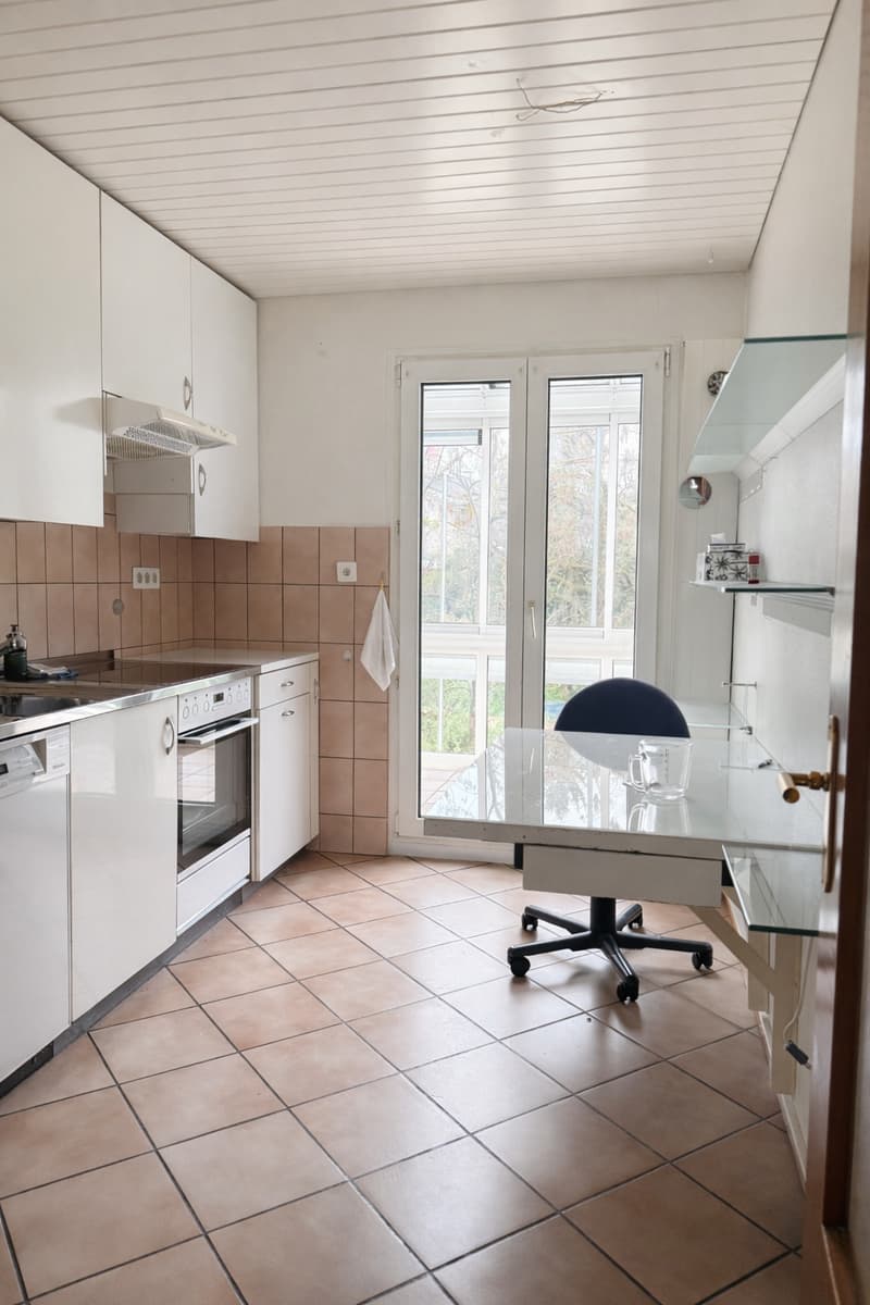 white cabinets, tiled floor, stainless steel appliances, glass door, office chair