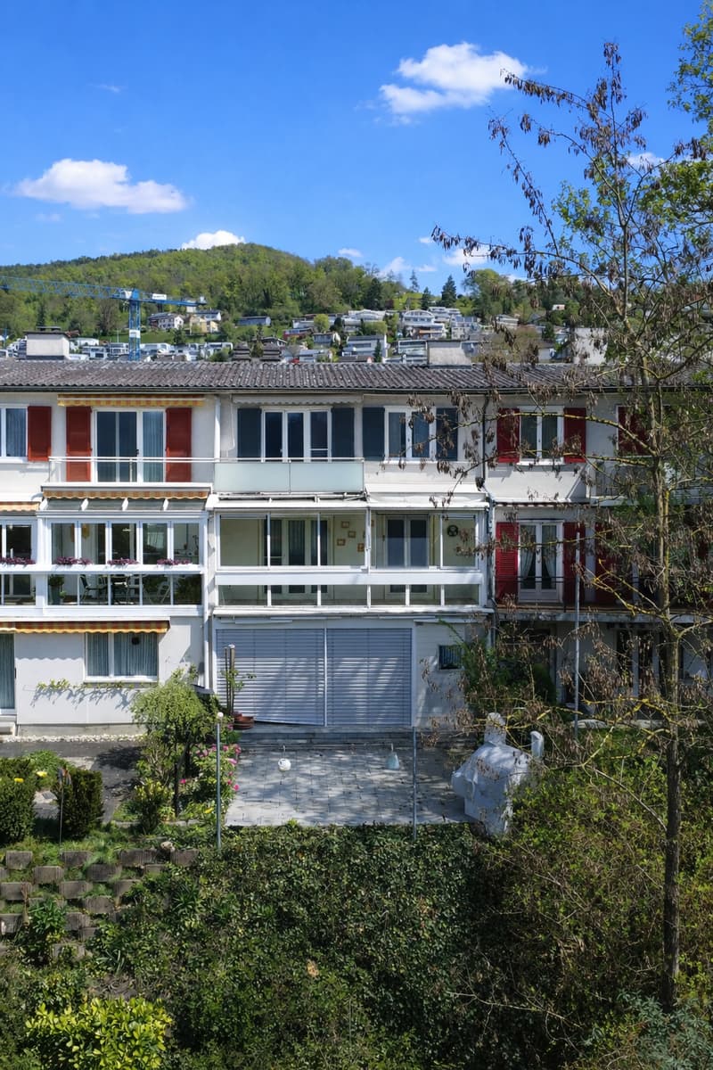 3 story house, white exterior, red shutters, garage, balconies, garden