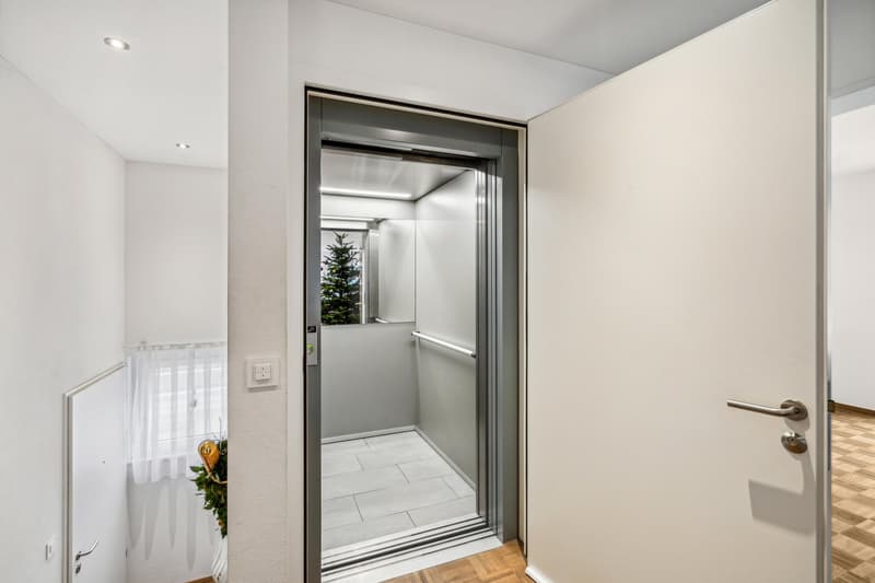 elevator, white walls, white ceiling, white door, white tiled floor, white window curtain