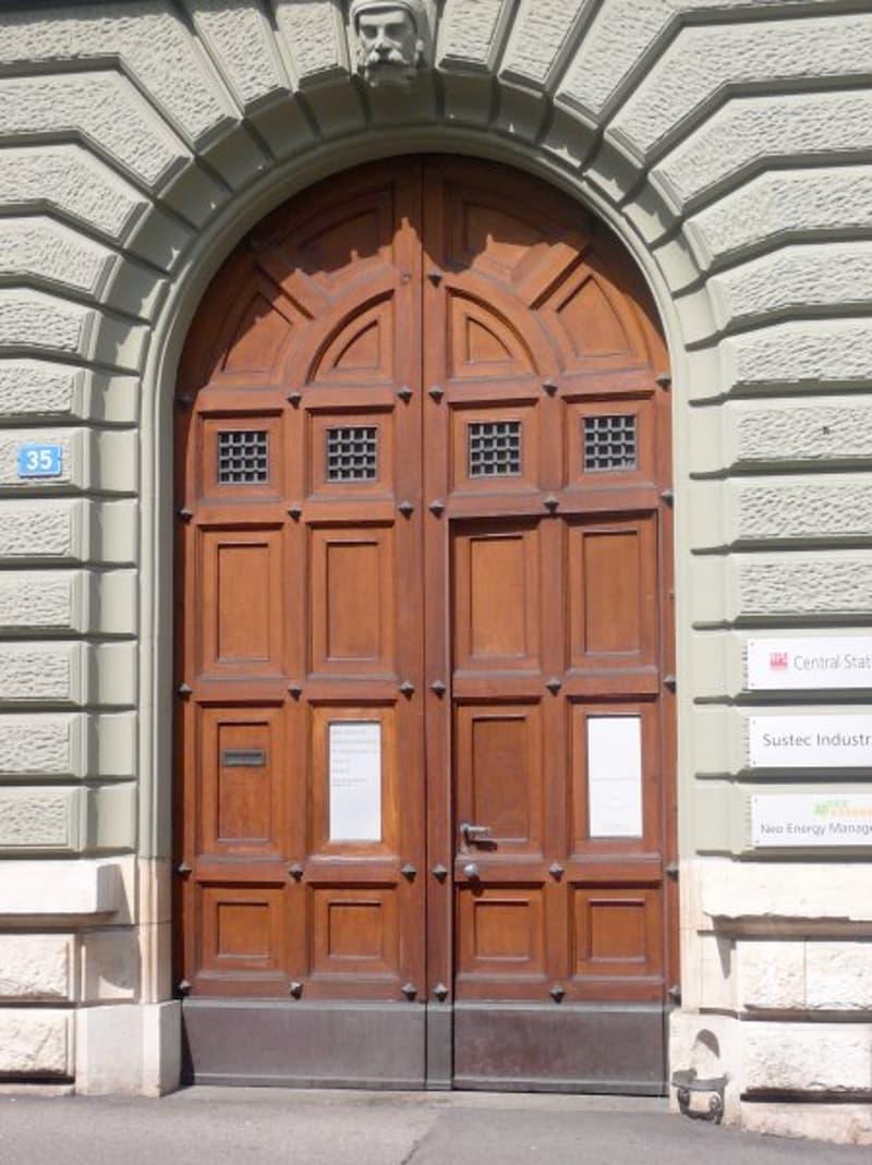 Large wooden double door, stone walls, decorative patterns