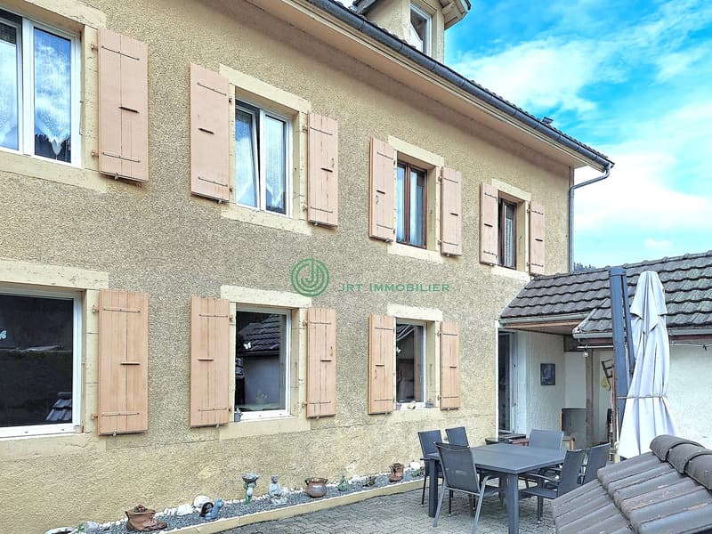 3 story house, beige exterior, wooden shutters, outdoor dining area, garden, terrace