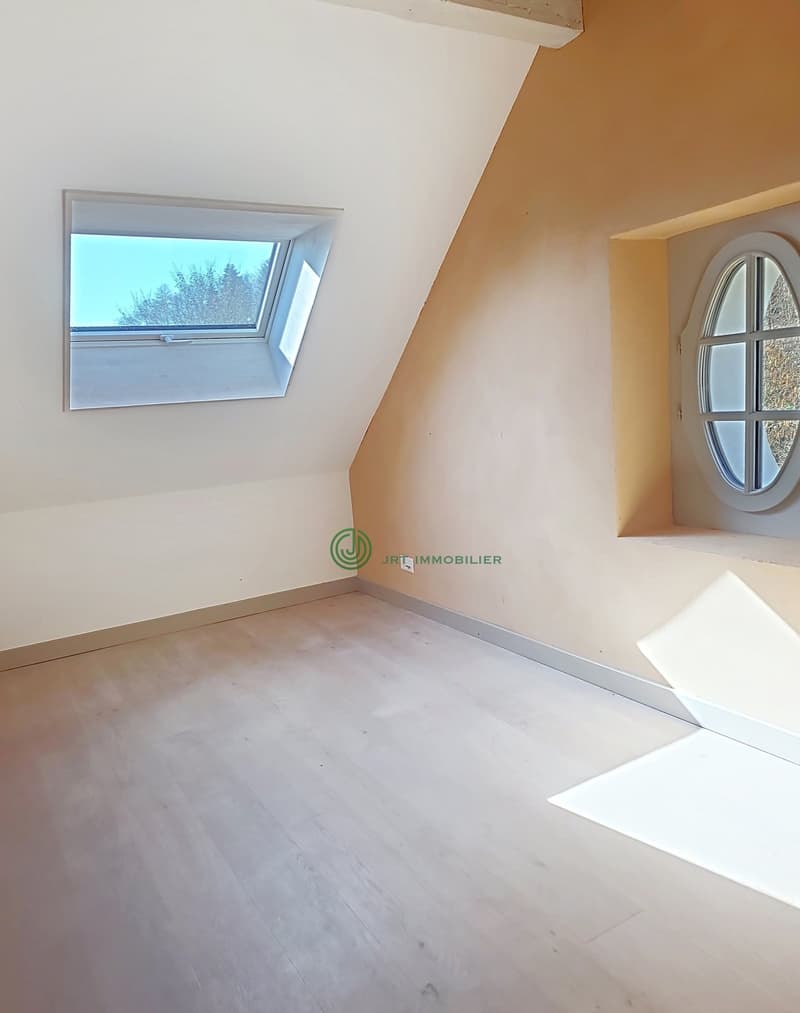 empty room, white floor, two windows, angled ceiling
