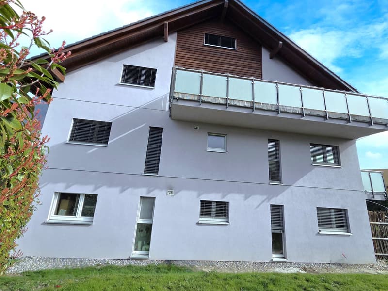 3 story house, white exterior, brown wooden accents, multiple windows, balcony on second floor