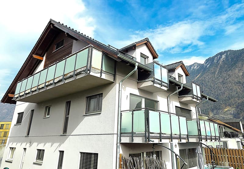 3 story house, white exterior, brown roof, multiple balconies, mountain view