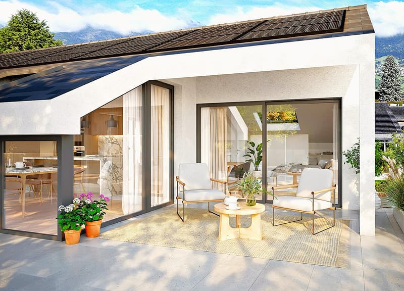Modern house with solar panels, glass doors, wooden table, chairs, plants, and a view of the mountains