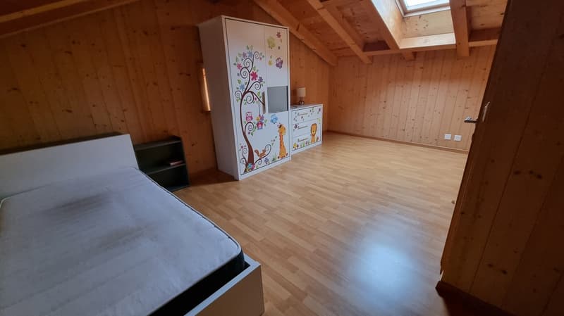 bedroom with bed, wardrobe, lamp, wooden floor, wooden walls