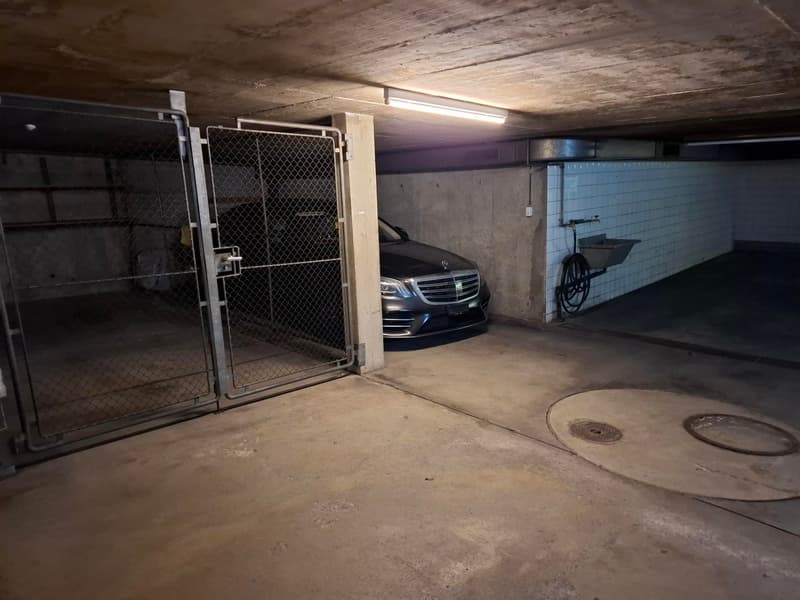 underground parking garage, metal gate, car parked, sink mounted on the wall