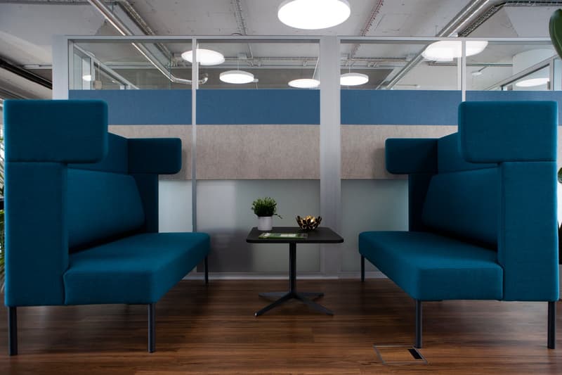 modular seating, desk, soft pillows, metal stands, wooden floor, ambient lighting