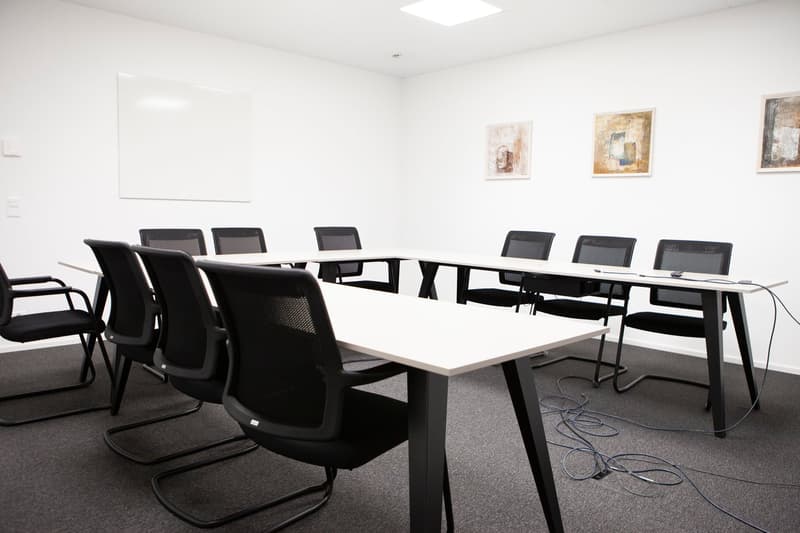 tables, chairs, whiteboard, artworks, carpet