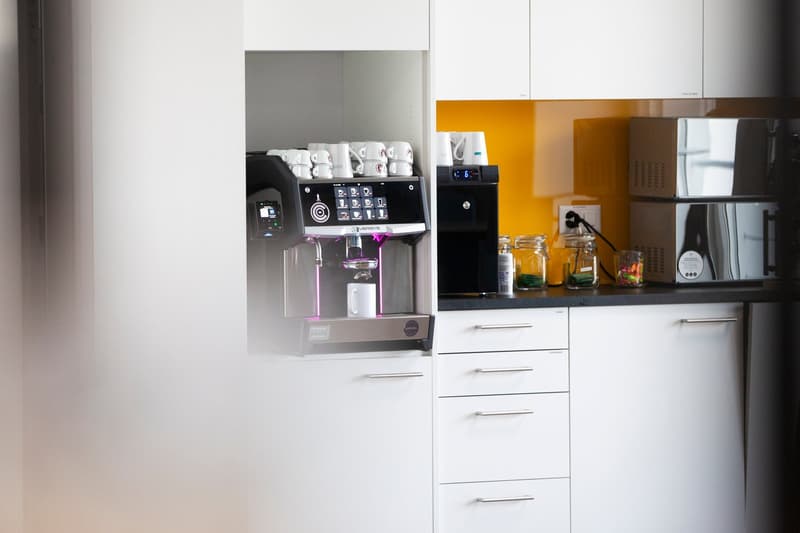 modern kitchen, espresso machine, sink, drawers, cupboards, microwaves, kettle, coffee cups