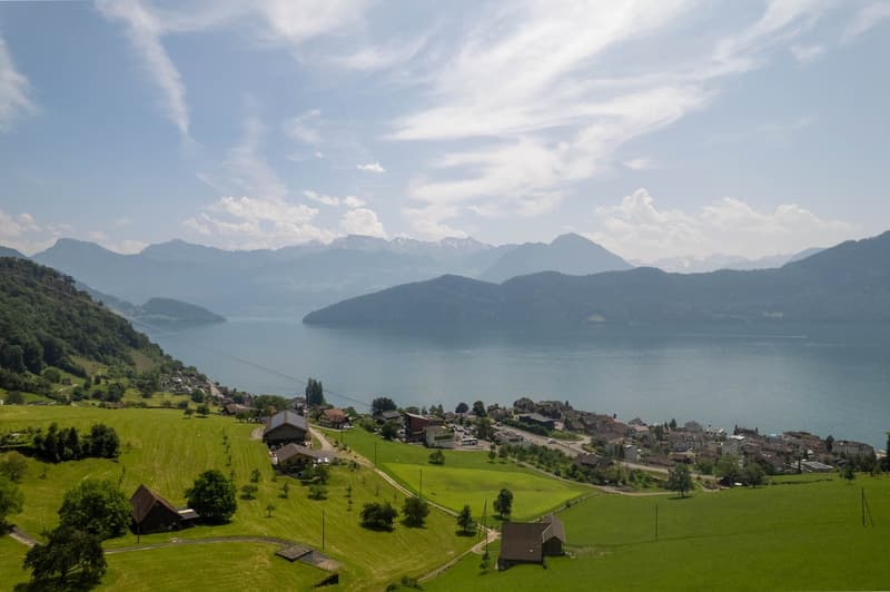Lake and mountains in the distance, houses, fields