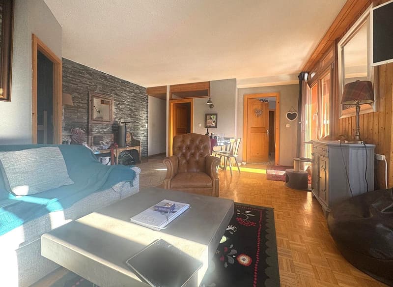 wooden floor, fireplace, sofa, armchair, coffee table, rug, cabinet, lamp, mirror, picture frames