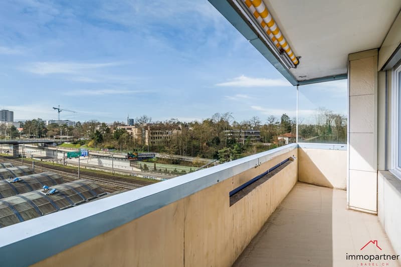 Balcony with a view of the city, large windows, modern design